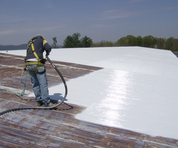 worker using polyurethane to treat the surface of a roof