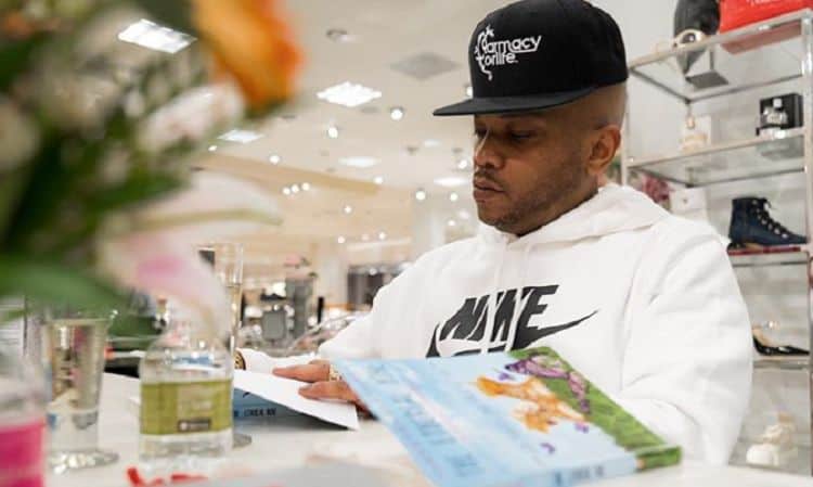Styles P wearing a white Nike Sweater with a black face cap