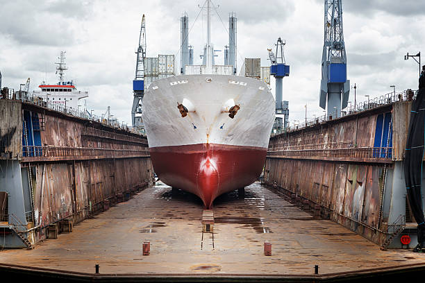 a red and white color ship stocked in a shipyard