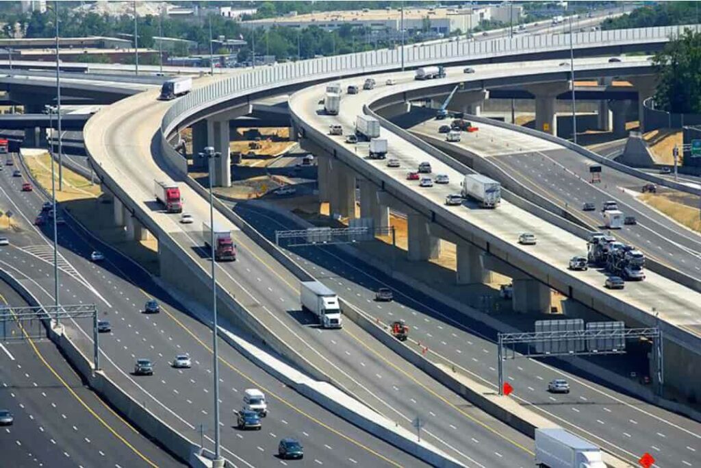 a flyover of multiple lanes with many vehicle passing 