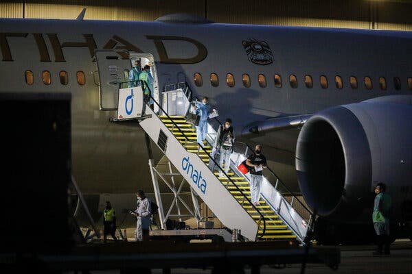 Tennis players and their support teams disembarking on Thursday from one of 17 flights that the organizers of the Australian Open chartered to bring participants to Melbourne.
