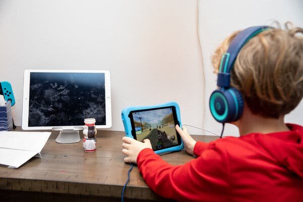 Jesse Taylor, 8, playing on his iPad. Children are increasingly entertaining themselves with digital devices during the pandemic.