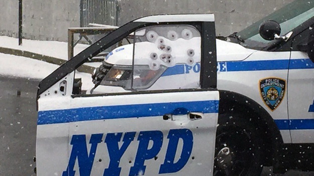 police car with scratched windows and doors