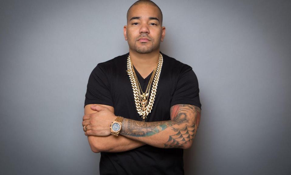 DJ Envy wearing a black top with gold chains on his neck