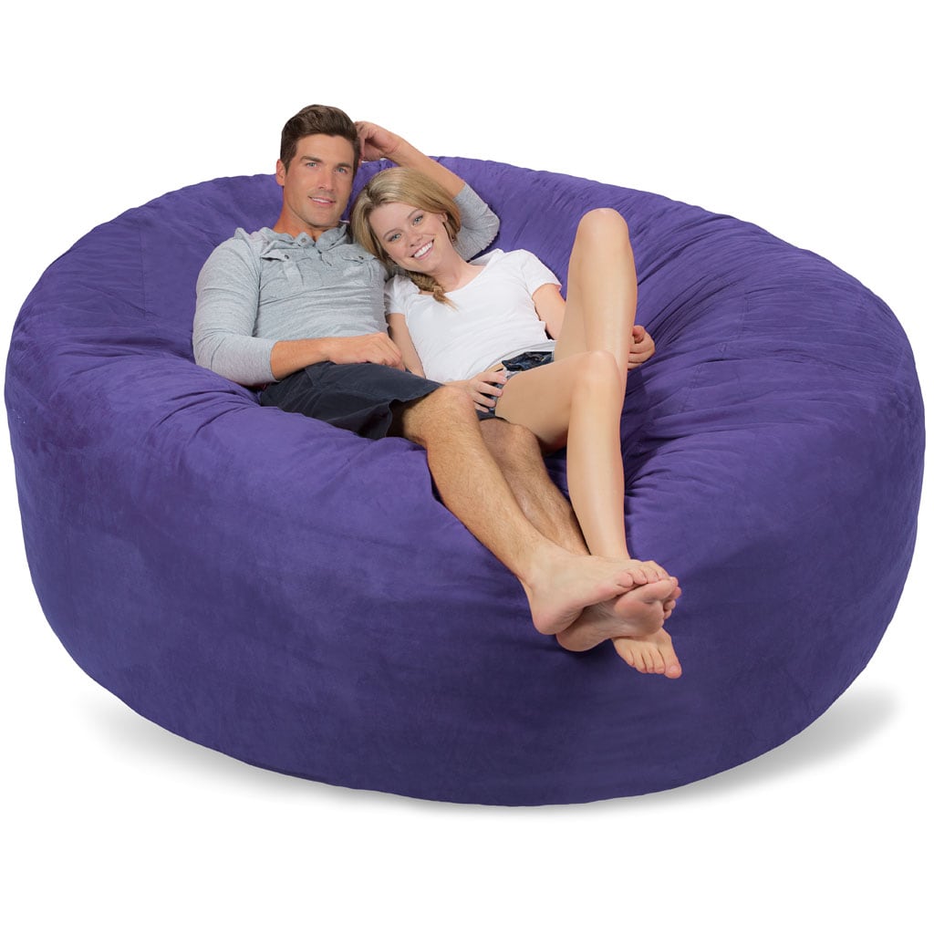 a man and a woman sitting on a purple bean bag together