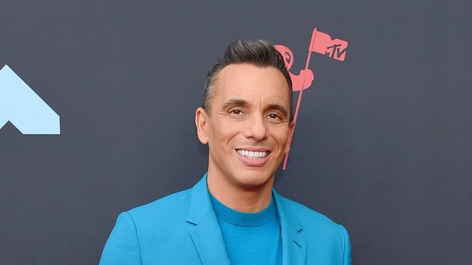 Sebastian Maniscalco smiling and wearing a light blue suit