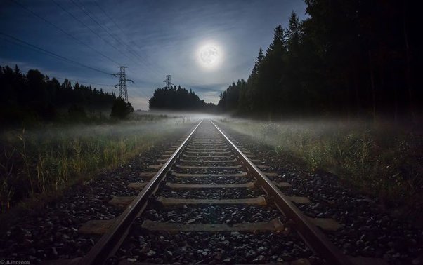 moon shining bright towards a rail way track 