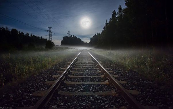 moon shining bright towards a rail way track
