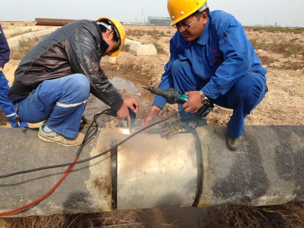 workers using cathodic protection on an underground pipeline 