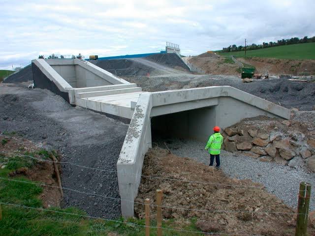 man standing in front of a constructed cantilever retaining wall